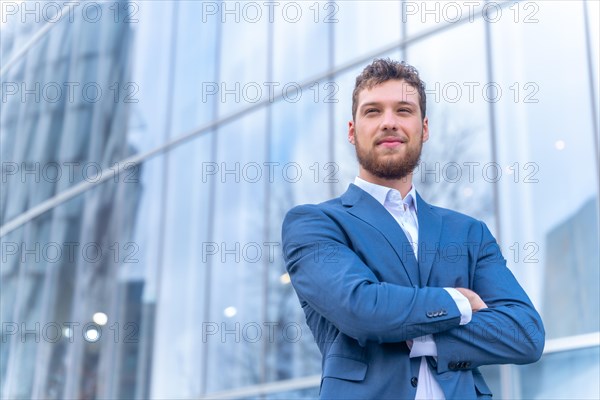 Portrait of corporate male entrepreneur outside the office in a glass building