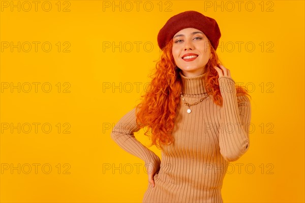 Red-haired woman in a red beret on a yellow background