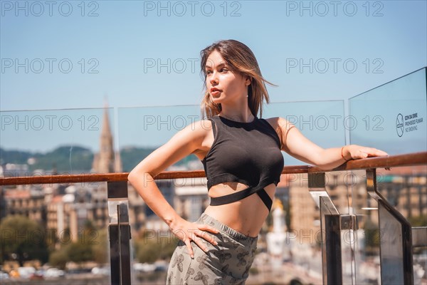 A young model in a viewpoint of the city from the heights