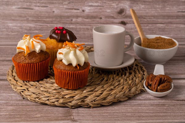 Assortment of chocolate and cream and carrot cupcakes on various backgrounds