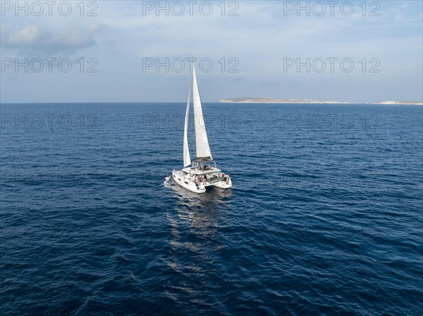 Sailing catamaran in full sail