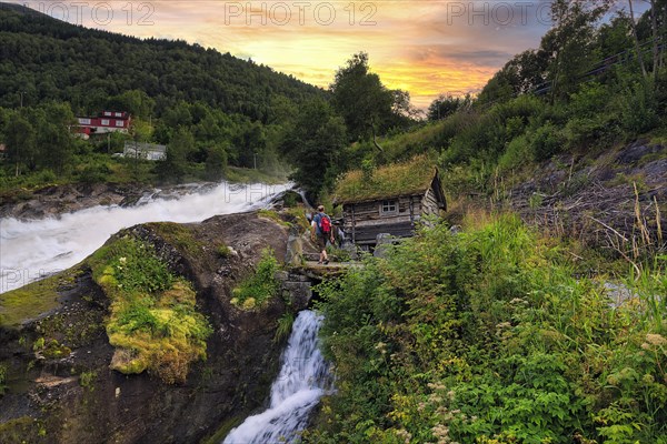 Hikers at Hellesyltfossen waterfall