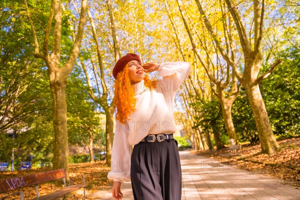 Red-haired woman with beret in a park