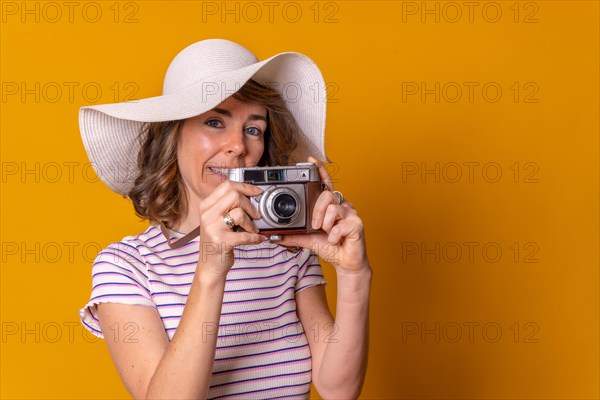 Caucasian girl in tourist concept with hat taking a photo enjoying summer vacation