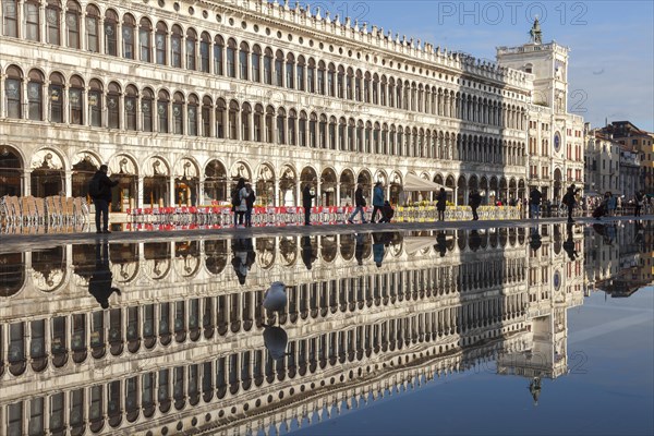 Reflection of the Procuratie Vecchie and the Torre dell Orologio in the high water of the Macus Square