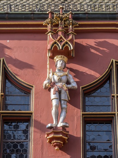 Statue on the facade of the Historic Red Department Store on Muensterplatz