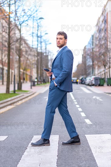 Businessman or finance man crossing a zebra crossing near the office