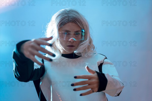 Woman looking through the illuminated futuristic glasses