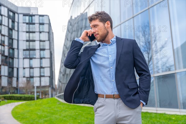 Businessman or finance man talking on the phone outside the office