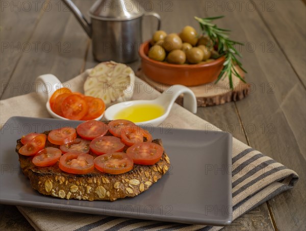 Toast bread with cherry tomato and olive oil with rosemary