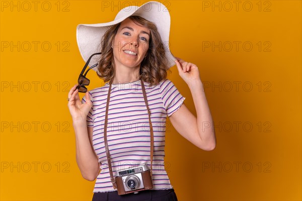 Portrait of a caucasian girl in tourist concept smiling with a hat and sunglasses enjoying summer vacation
