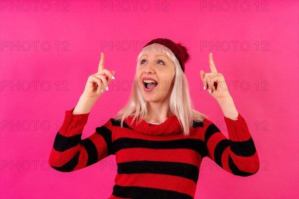 Blonde caucasian girl on pink background studio