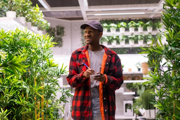 Black ethnic man shopping in a market garden