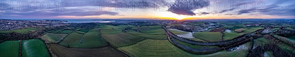 Panorama of Sunset over Fields and Farms shrouded in frost from a drone