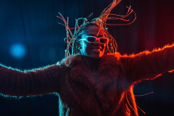Black ethnic woman with braids with blue and red led lights