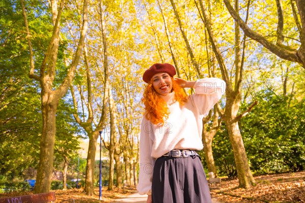 Red-haired woman with beret in a park