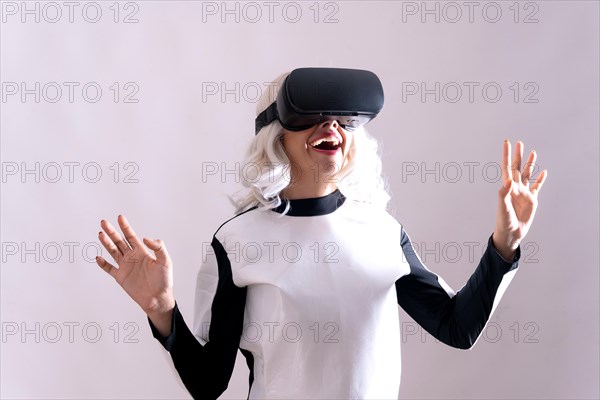 Close-up of adult woman gesturing with virtual reality glasses isolated on white background