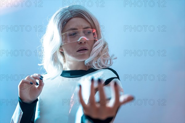 Woman with the illuminated futuristic glasses and white hair