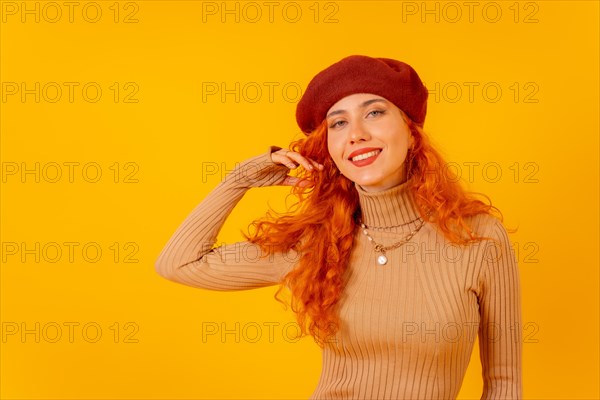 Red-haired woman in a red beret on a yellow background