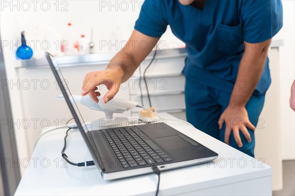 A doctor in the dental clinic explaining and looking at the 3d of the x-ray on the computer