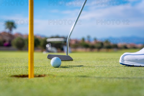 Detail of a man playing golf