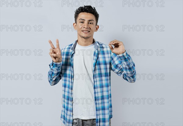 Smiling person gesturing anir and peace in sign language