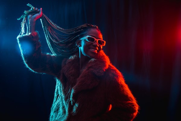 Black ethnic woman with braids with blue and red led lights