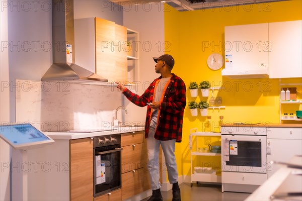 Black ethnic man shopping in a furniture store