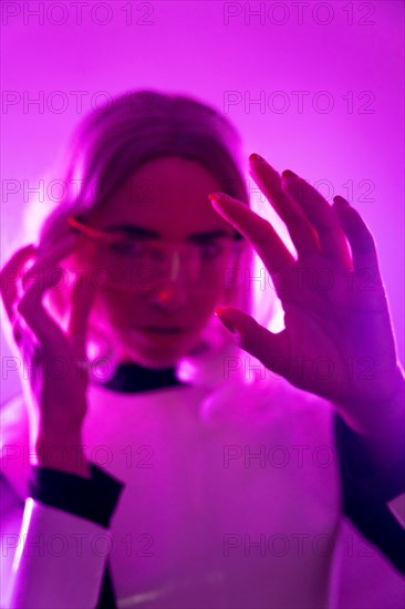 A woman in a suit and futuristic glasses with pink lights