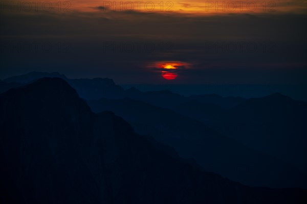 Fiery sunball at sunset with Lechtaler Alps