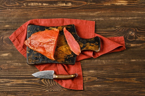 Top view of air dried turkey breast on wooden cutting board