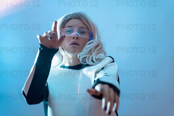 Woman watching with the illuminated futuristic glasses