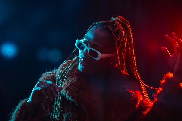 Black ethnic woman with braids with blue and red led lights