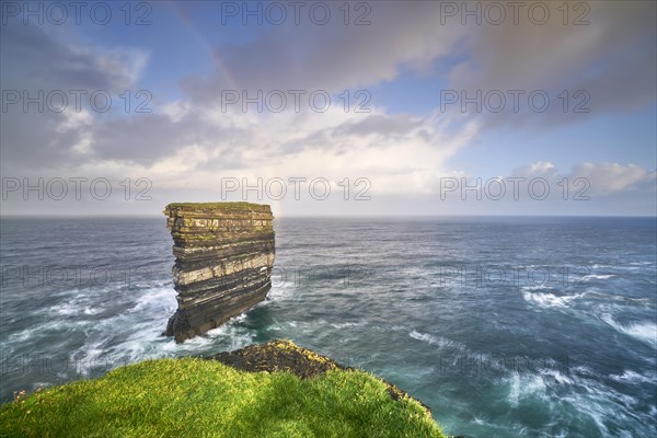 Downpatrick Head with gigantic rock with stormy Atlantic with rainbow