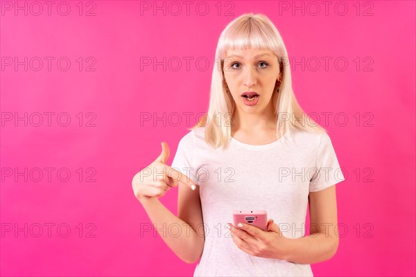 Blonde caucasian girl on pink studio background