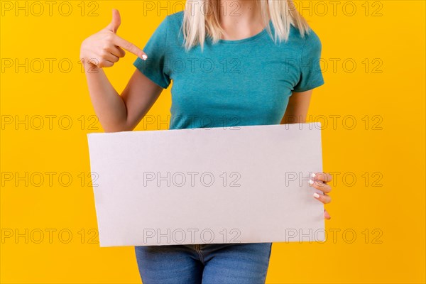 Pointing at white empty advertisement poster