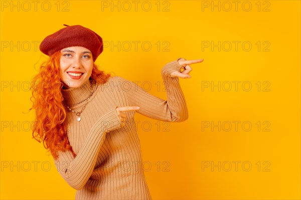 Red-haired woman in a red beret on a yellow background