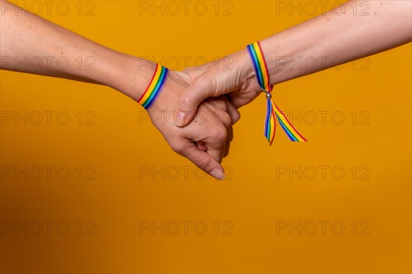 Detail of two hands of two women shaking hands with a bracelet