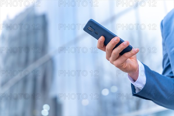 Unrecognizable person corporate businessman outside the office in a glass building