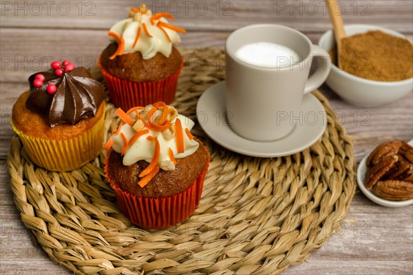 Assortment of chocolate and cream and carrot cupcakes on various backgrounds