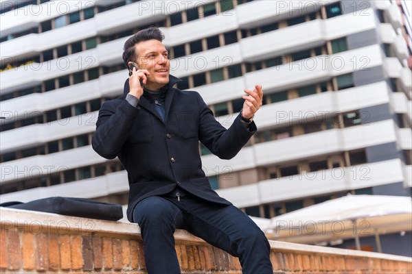 Middle-aged Caucasian businessman talking on the phone in the city