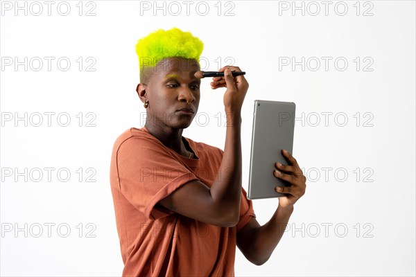 A gay black man putting on makeup