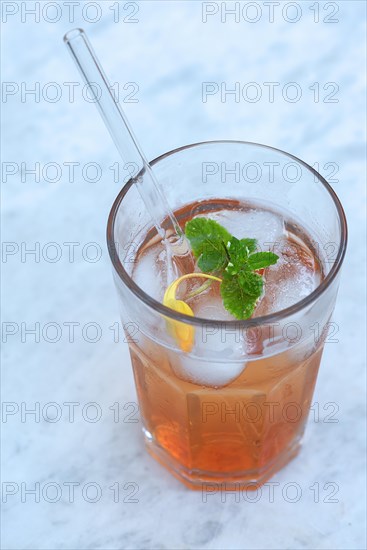 Glass with quince juice and a glass straw