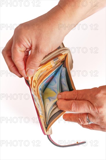 Woman's hands taking euro banknotes out of her wallet with white background and copy space