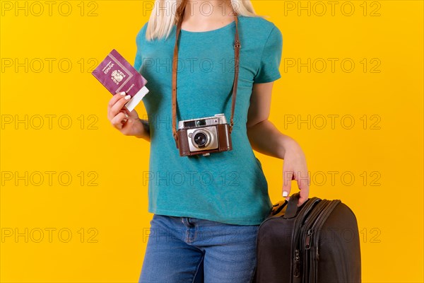 Unrecognizable person tourist with suitcase and passport