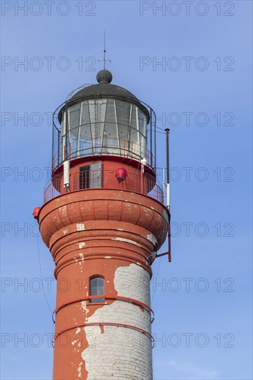 Weathered lighthouse in the evening light against a blue sky on Pakri Peninsula