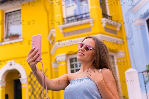 Portrait attractive young blonde woman taking a photo