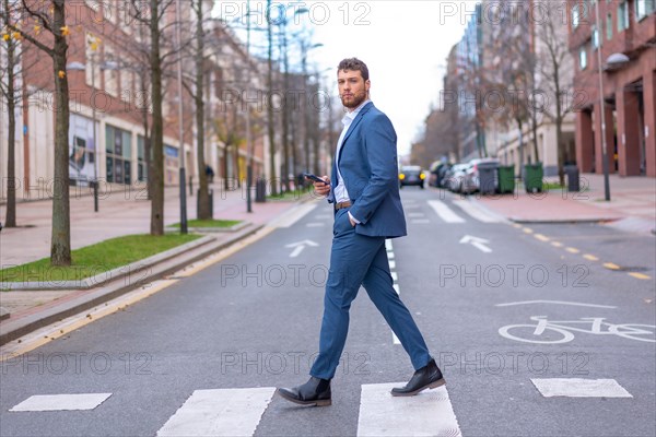 Businessman or finance man crossing a zebra crossing heading to the office at the time of rest