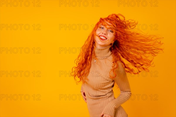 Red-haired woman on a yellow background