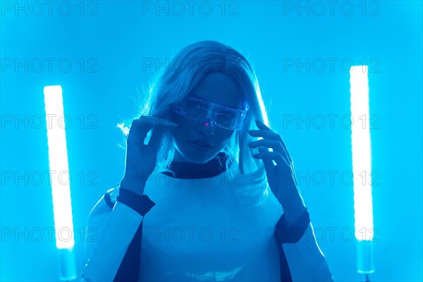 A woman in a futuristic suit and glasses with blue lights